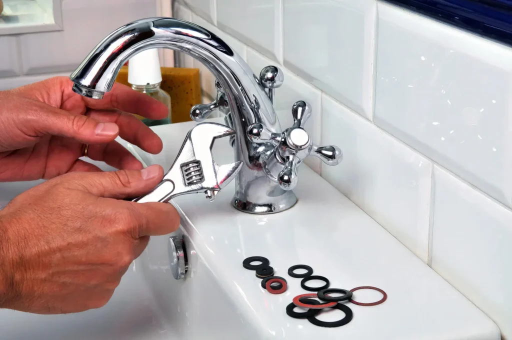 Plumber performing maintenance on a bathroom faucet in Winter Park