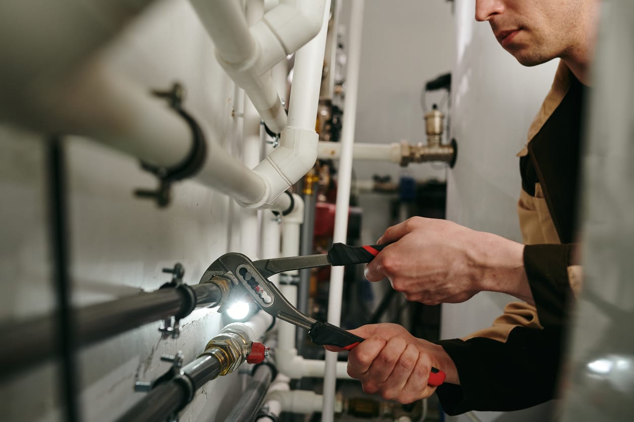 Plumbers maintaining commercial plumbing pipes in Winter Park
