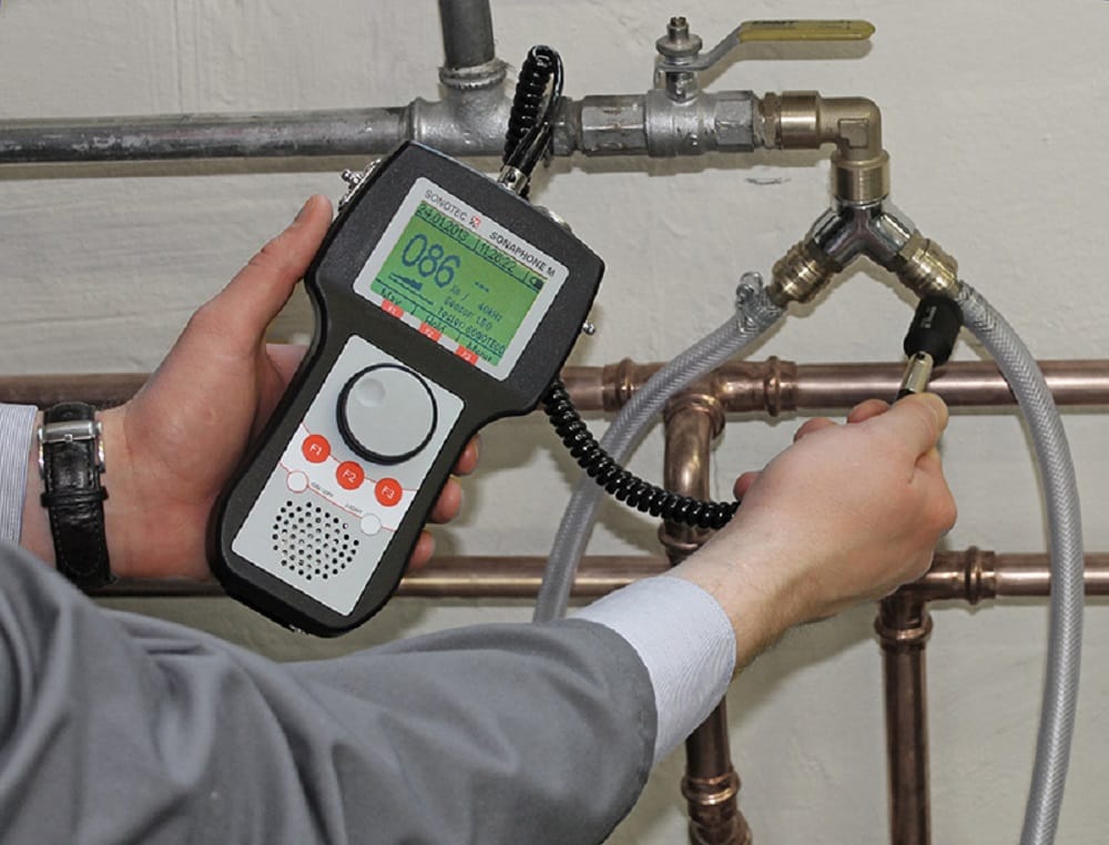 Plumber testing pipes with electronic leak detection equipment in Winter Park