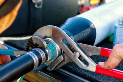 Technician tightening an industrial pipe connection in Winter Park