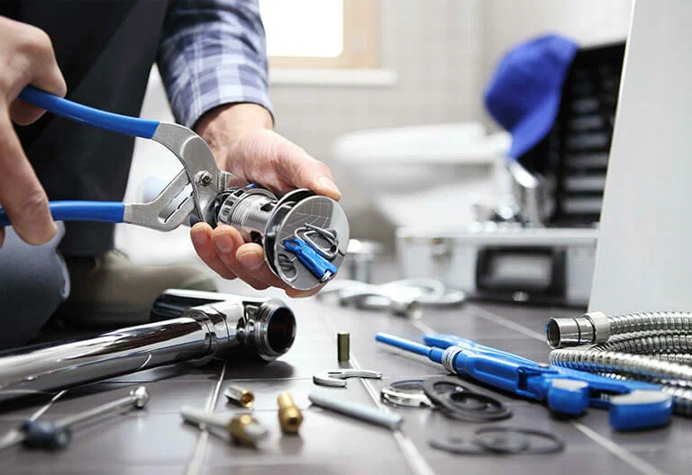Technician repairing a plumbing fixture with professional tools in Winter Park