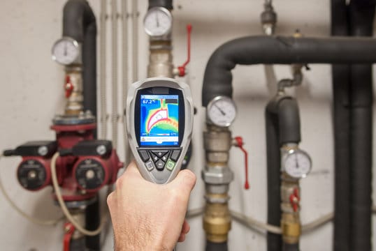 Plumber using a thermal imaging camera to inspect pipes in Winter Park