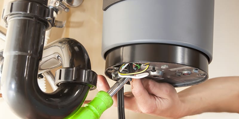 Technician repairing the heating element of a water heater in Winter Park