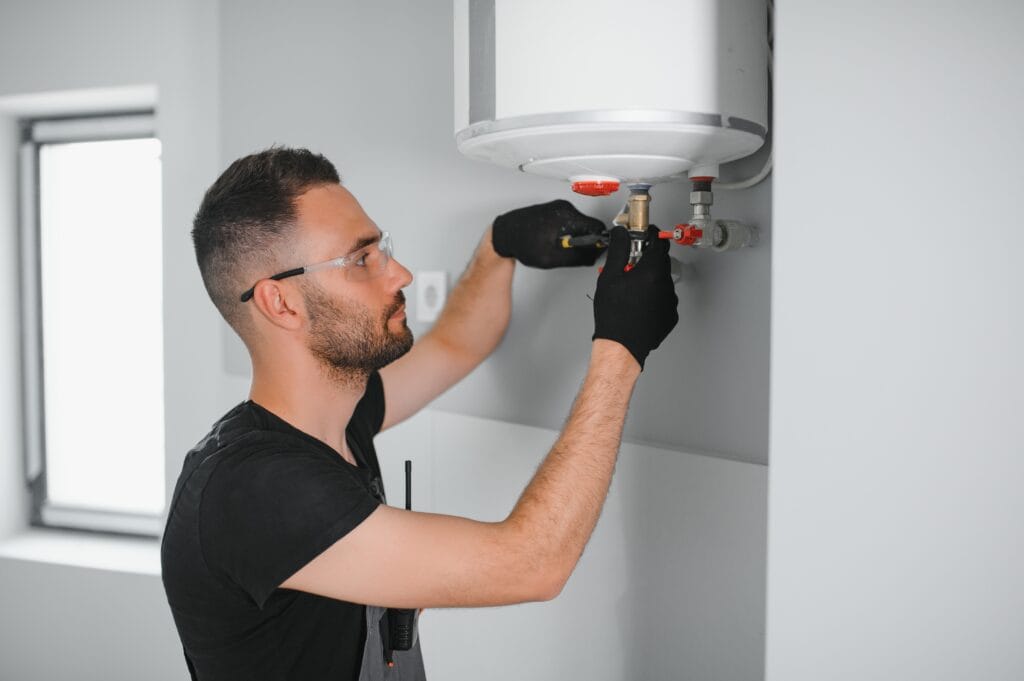 Technician performing water heater maintenance in Winter Park