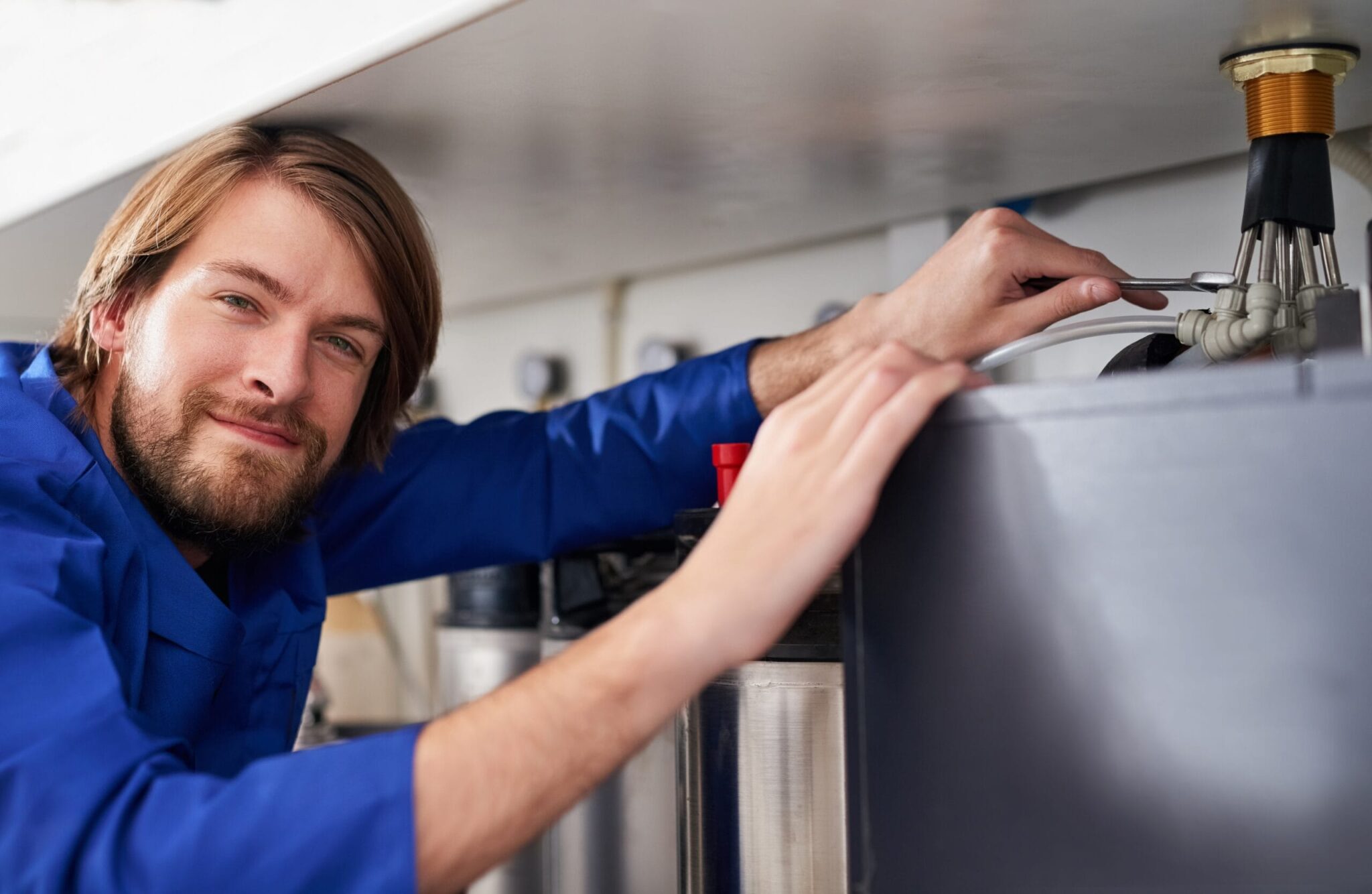 Technician servicing a residential water heater tank in Winter Park