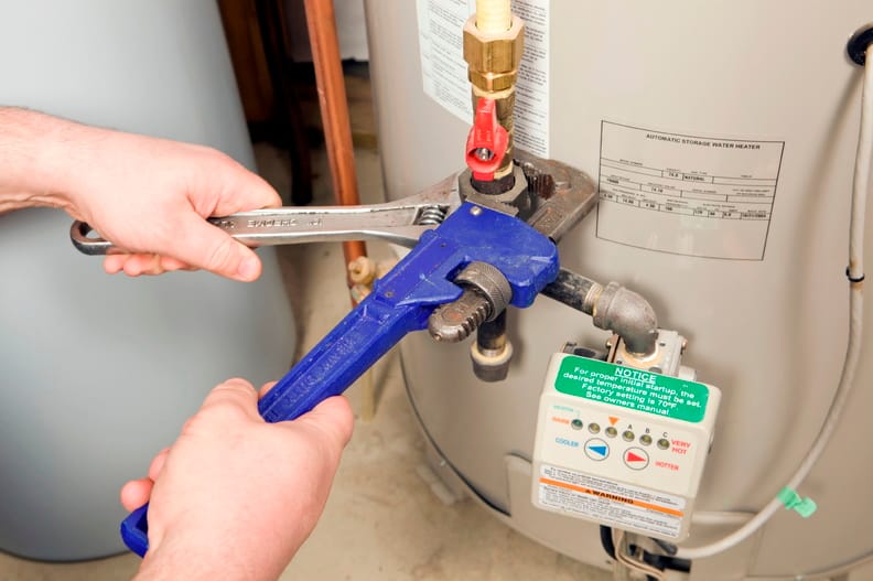 Plumber repairing a water heater valve in Winter Park